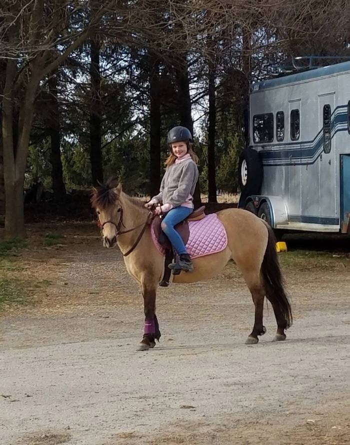 Lily on Daisy with pink saddle pad